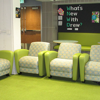 Photo of chairs in Drew office with the question What's new with Drew? behind them.