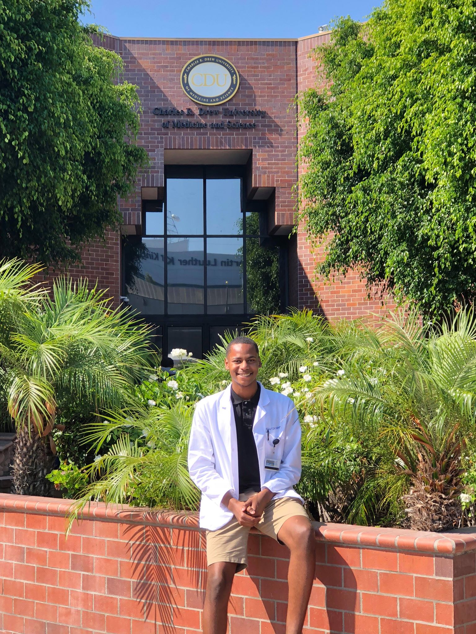 Marcel posing outside of Charles Drew University School of Medicine
